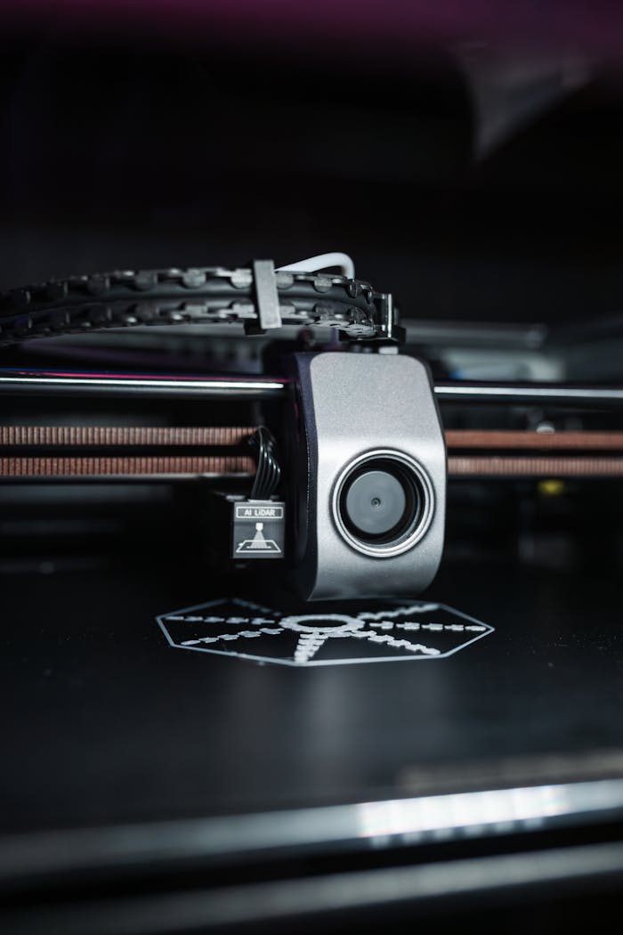 about-us Detailed close-up view of a modern 3D printer in operation, focusing on the printhead.