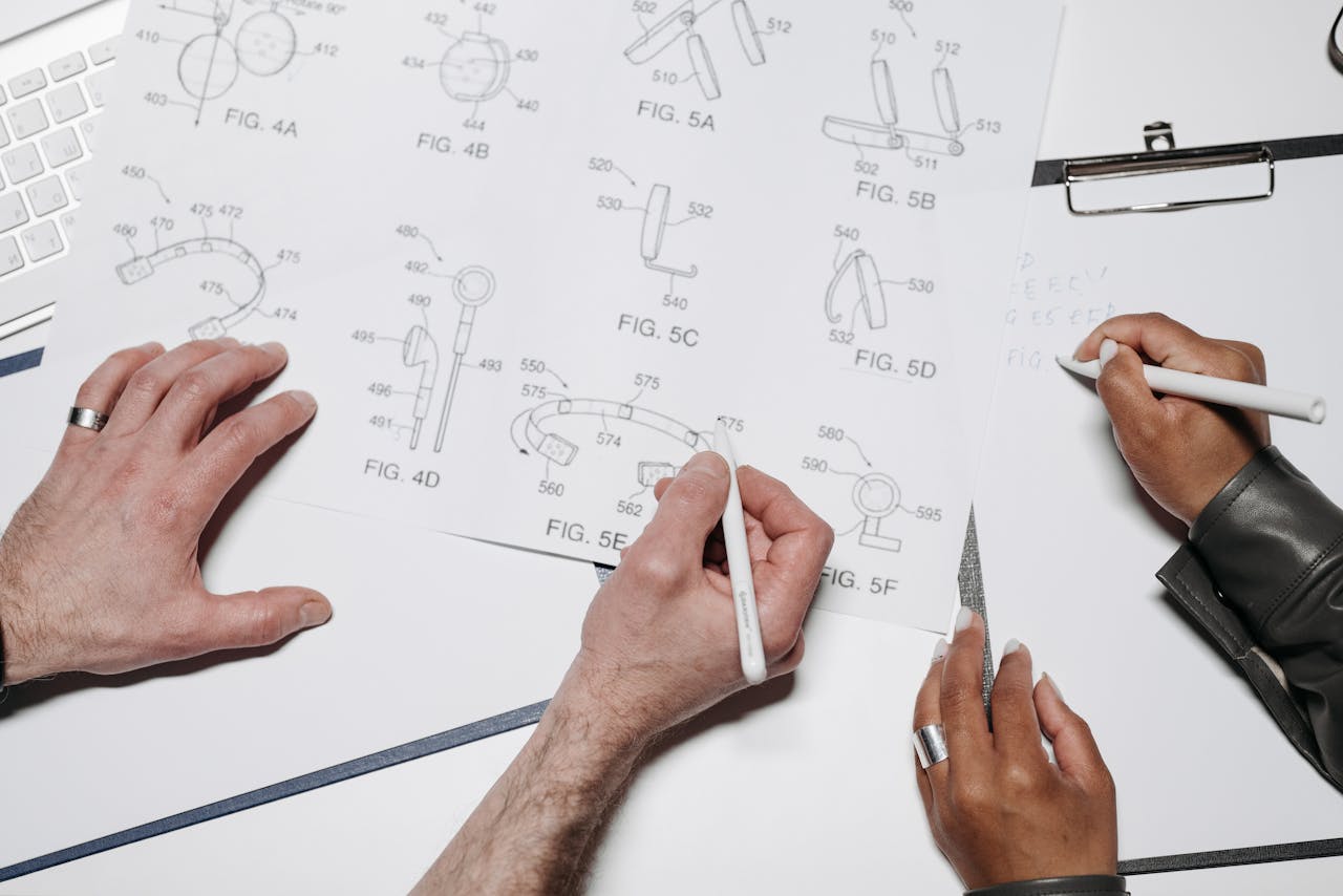 heros-img Two people collaborating over technical drawings in a well-lit workspace.